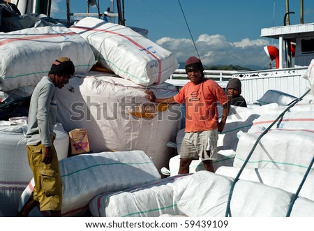 LABUANBAJO, INDONESIA-JULY 21: men on a cargo ship July 21, 2010 in Labuanbajo.Developing countries mostly don\'t have load carriage standards to identify physiological cost of load carriage on workers