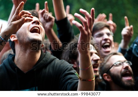 MILAN, ITALY - JUNE 10: unidentified group of people cheer during the Mi Ami music festival in Milan on June 10, 2011. The Mi Ami festival is held annually each June in Milan.