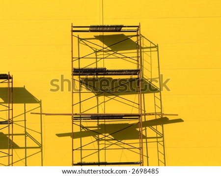 Constructions scaffolding on the yellow wall background
