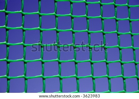 Green net on dark blue sky background