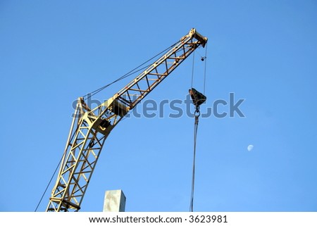 Lifting crane on blue sky background.