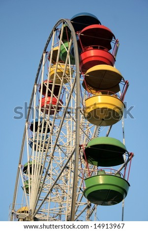 Wheel of review in Amusement park on blue sky background