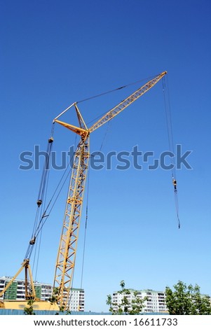 hoisting crane on blue sky background