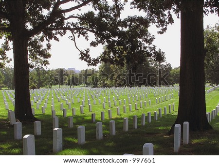 White gravestones at Arlington National Cemetery, marking the final resting place of American heroes.  The color image is in horizontal orientation with copy space for text