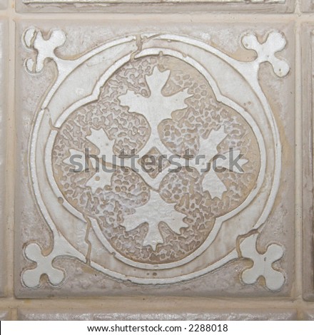 Color DSLR picture of square off white, tan or beige decorative ceramic tile with flower pattern