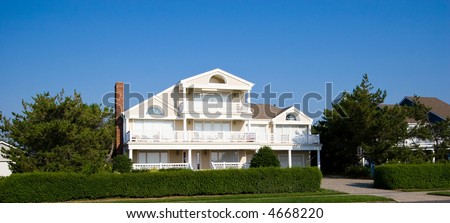 Color DSLR picture of an isolated luxury vacation beach houses on the New Jersey shore with a clear blue sky background. Horizontal with copy space for text.