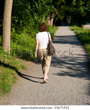Woman walking on a path, from behind