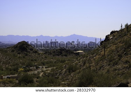 City of Phoenix, Arizona, in a valley between mountains; in horizontal orientation