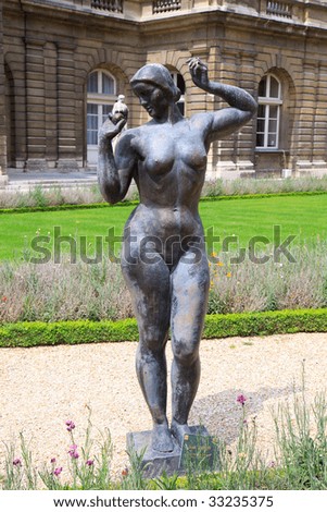 Color DSLR image of ancient bronze metal statue of nude woman in the Luxembourg Gardens, Paris, France. Park is popular Left Bank, Latin Quarter destination. Vertical with copy space for text.