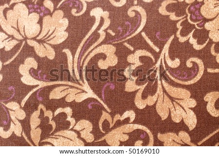 stock photo Brown paisley fabric with tan and blue accents in horizontal 
