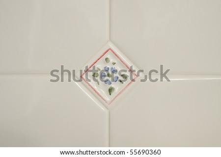 White Bathroom tiles; in horizontal orientation and a decorative tile in the center