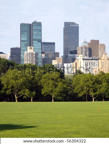 New York City skyscrapers seen across the Sheep\'s Meadow, Central Park; in vertical orientation
