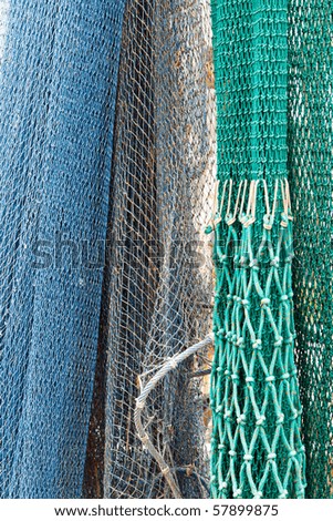 Color DSLR picture of Multi-colored commercial fishing nets; in vertical orientation