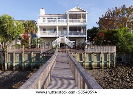 Luxury beach house, seen from its dock, Sunset Beach, North Carolina; in horizontal orientation