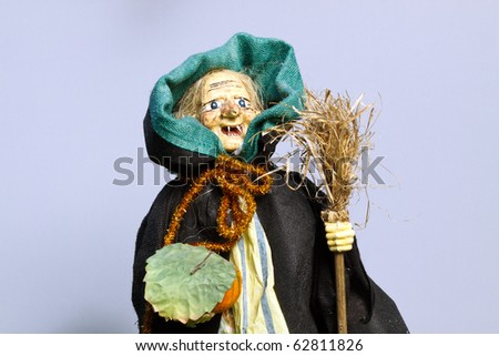 Witch doll on grey background, with copy space for text