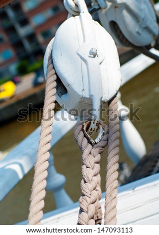 Pulley with ropes on deck of ship