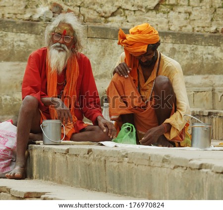 Varanasi, India - Oct 1: An Unidentified Sadhu With Traditional Painted Face And Body, Sits At The Ghat Along The Ganges On October 1, 2013 In Varanasi, India.
