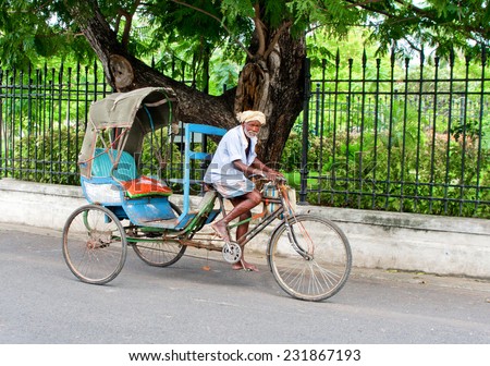 PONDICHERRY (PUDUCHERRY), INDIA - OCT 12, 2014: Old indian  rickshaw man on his bike  on the street in Pondicherry also known as Puducherry, India, on 12 Oct 2014