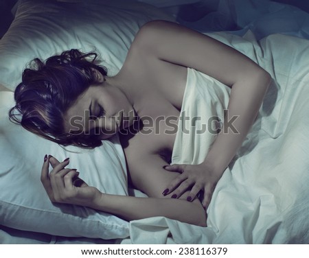 Young woman sleeping at night in bed