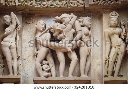 Stone carved erotic bas-relief in Hindu temple in Khajuraho, India. Unesco World Heritage Site