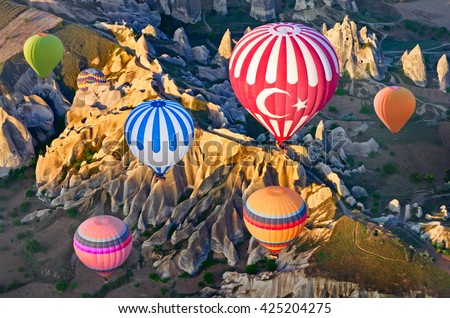 Hot air balloons over mountain landscape in Cappadocia, Goreme National Park, Turkey. Aerial view from air balloon