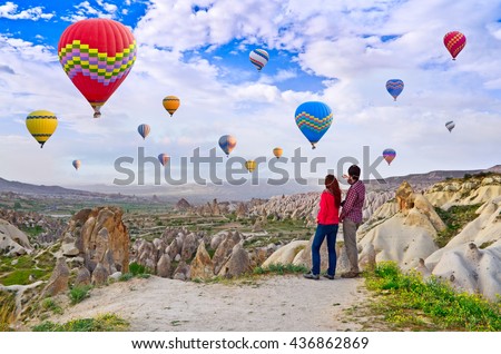 Couple of hikers enjoying valley view in Cappadocia, Turkey,