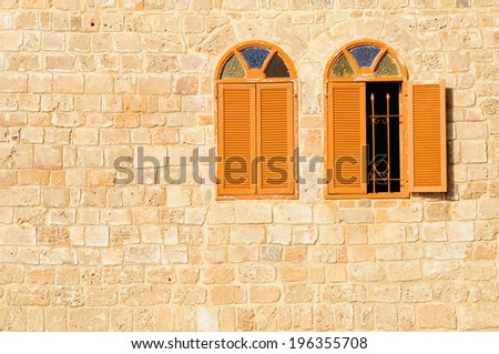 Two shuttered windows in stone wall of  Jaffa mosque.  Israel.