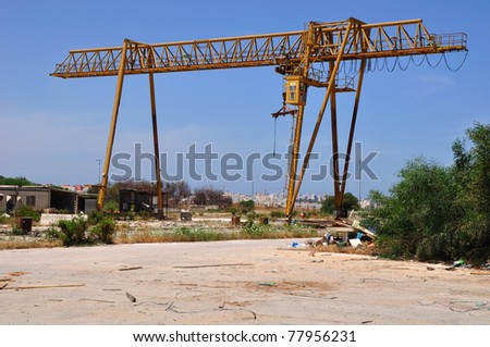 Industrial crane in abandoned factory zone.