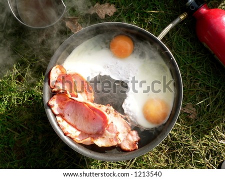 bacon and eggs cooked  on a camping stove