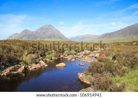river running through the barren moors of glen coe pass in the highlands of scotland