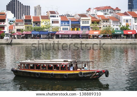 CLARKE QUAY, SINGAPORE - MAY 11: Tourist boat cruising the Singapore river on May 11 2008 in Singapore. The Singapore River has been the centre of trade since Singapore was founded in 1819