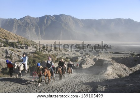MOUNT BROMO, JAVA - SEPT 26: tourists on horses climbing the slopes of  mount bromo volcano on Sept 26 2007 in JAVA. The active Mount Bromo is one of the most visited tourist attractions in East Java,