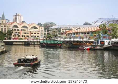 CLARKE QUAY, SINGAPORE-MAY 11:Tourist boat cruising the Singapore river on May 11 2008 in Singapore. The Singapore River has been the centre of trade since Singapore was founded in 1819.