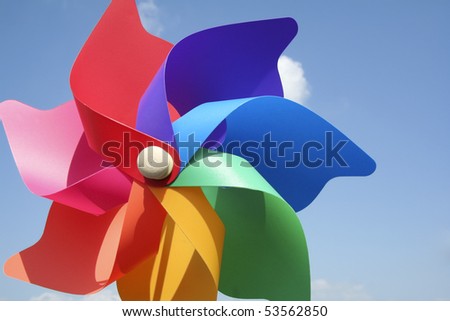close-up of childs plastic windmill toy shot against clear blue sky