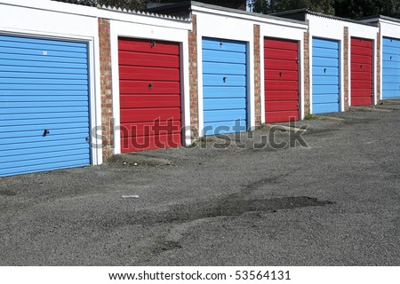 red and blue doors of lock-up garages on council housing estate