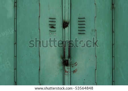 filthy dirty distressed green metal sliding doors