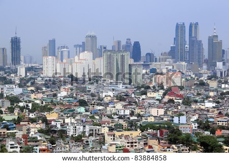 densley populated housing developments crowding high rise condominium ad commercial districts in ortigas and makati manila the philippines