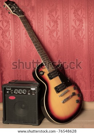 Guitar and amp, red background