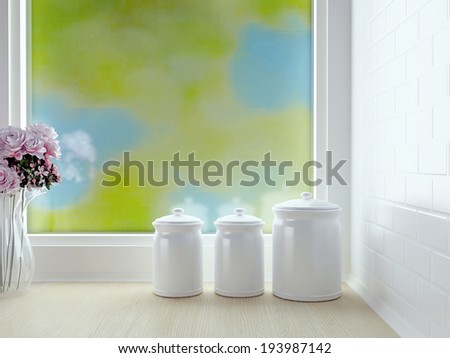 Kitchen worktop with containers and flowers in front of window. White kitchen design.