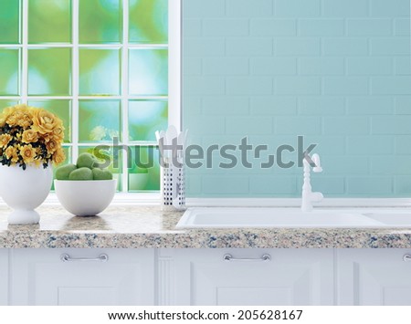 Kitchenware on the marble worktop in front of big light window. White kitchen design.