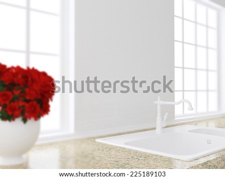 Red flowers on the marble worktop in front of big window. White sink. Kitchen design.