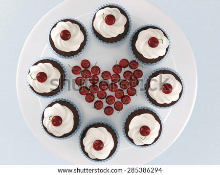 Chocolate cupcakes with ice-cream and cherries on a white stand.