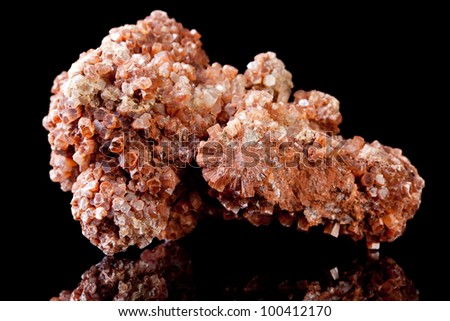 Vanadinite is a mineral containing the metals vanadium and lead and showing red hexagonal crystals
