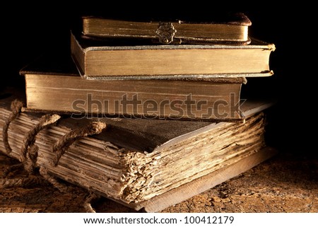 Small stack of antique books in weathered grungy state and gold edged