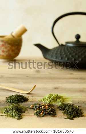 Green tea sorts from Japan with black teapot and bamboo whisk