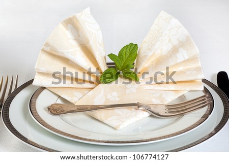 Silver festive cutlery and fancy folded napkins