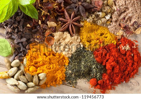 Green tea, herbs and spices on a wooden table