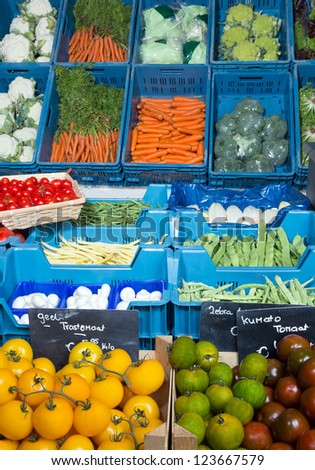 Vegetable display at a greengrocer\'s shop in Europe with price tags in euros, no brand names