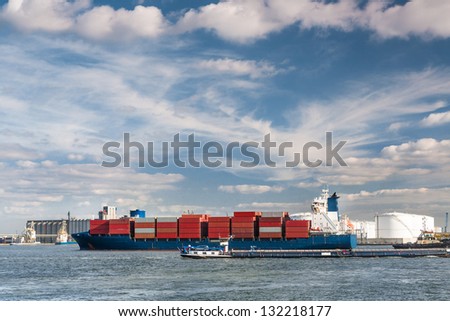 Large container ship entering Antwerp harbor - all brands and logos have been removed