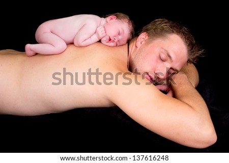 Little newborn baby of 11 days old sleeping on his father\'s bare back